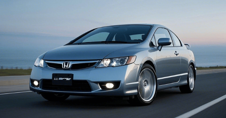 2009 Honda Civic Si cornering on a winding road at speed