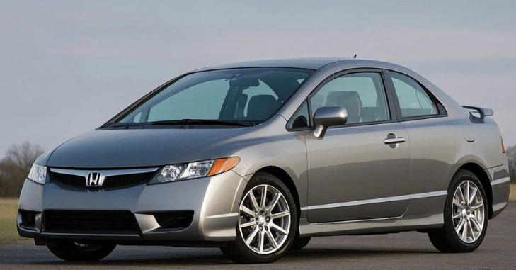 Mechanic performing routine maintenance on a Honda Civic Si engine